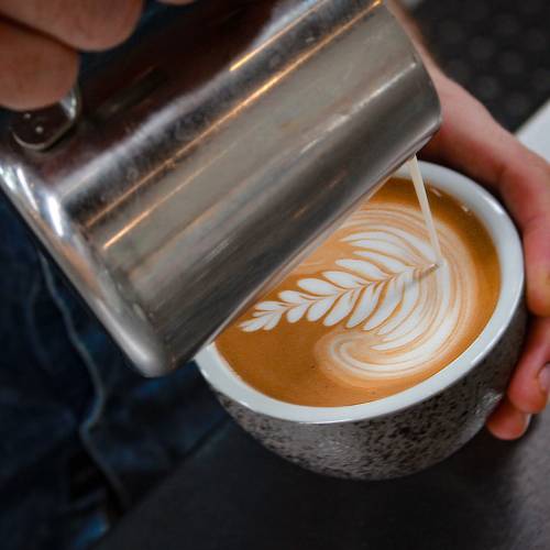 Pouring milk into coffee