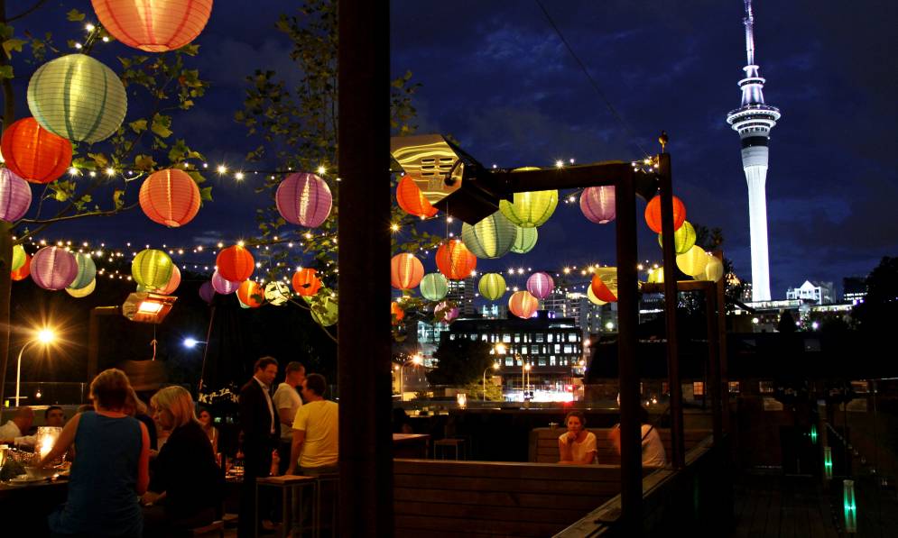 People sitting under lanterns
