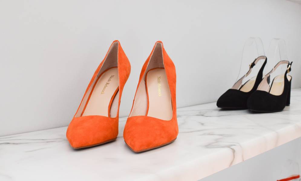 Orange shoes displayed on shelf