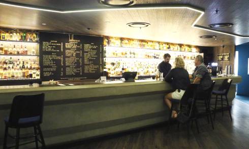 Customers being served by bartender at bar