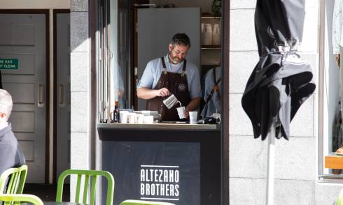 Barista pouring milk
