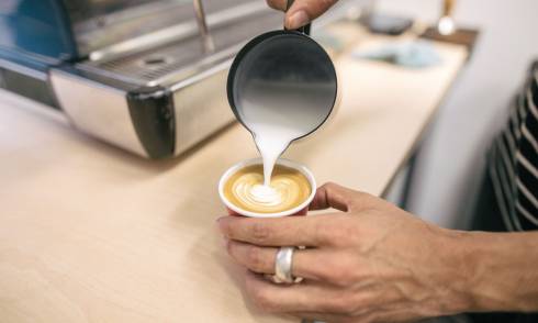 Pouring milk into coffee