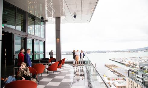 People standing and sitting at a rooftop