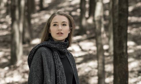 Model wearing garment in a forest