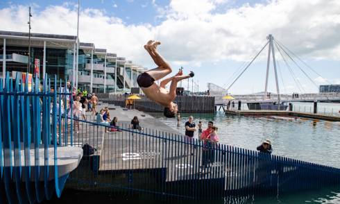 A person diving off of Karanga Plaza