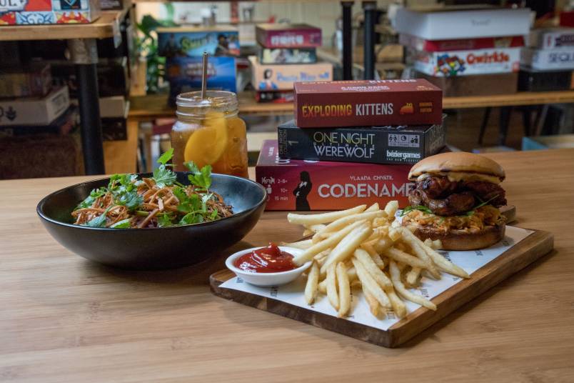 A meal and boardgames on a table