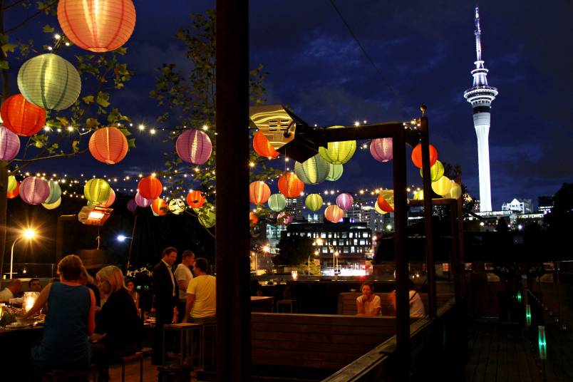 People sitting under lanterns