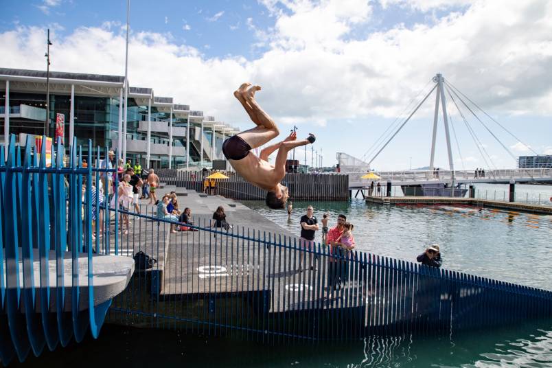 A person diving off of Karanga Plaza